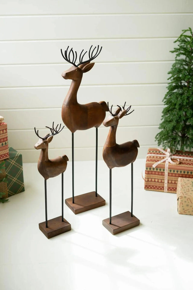 SET OF THREE CARVED WOOD AND IRON REINDEER ON BASES Kalalou